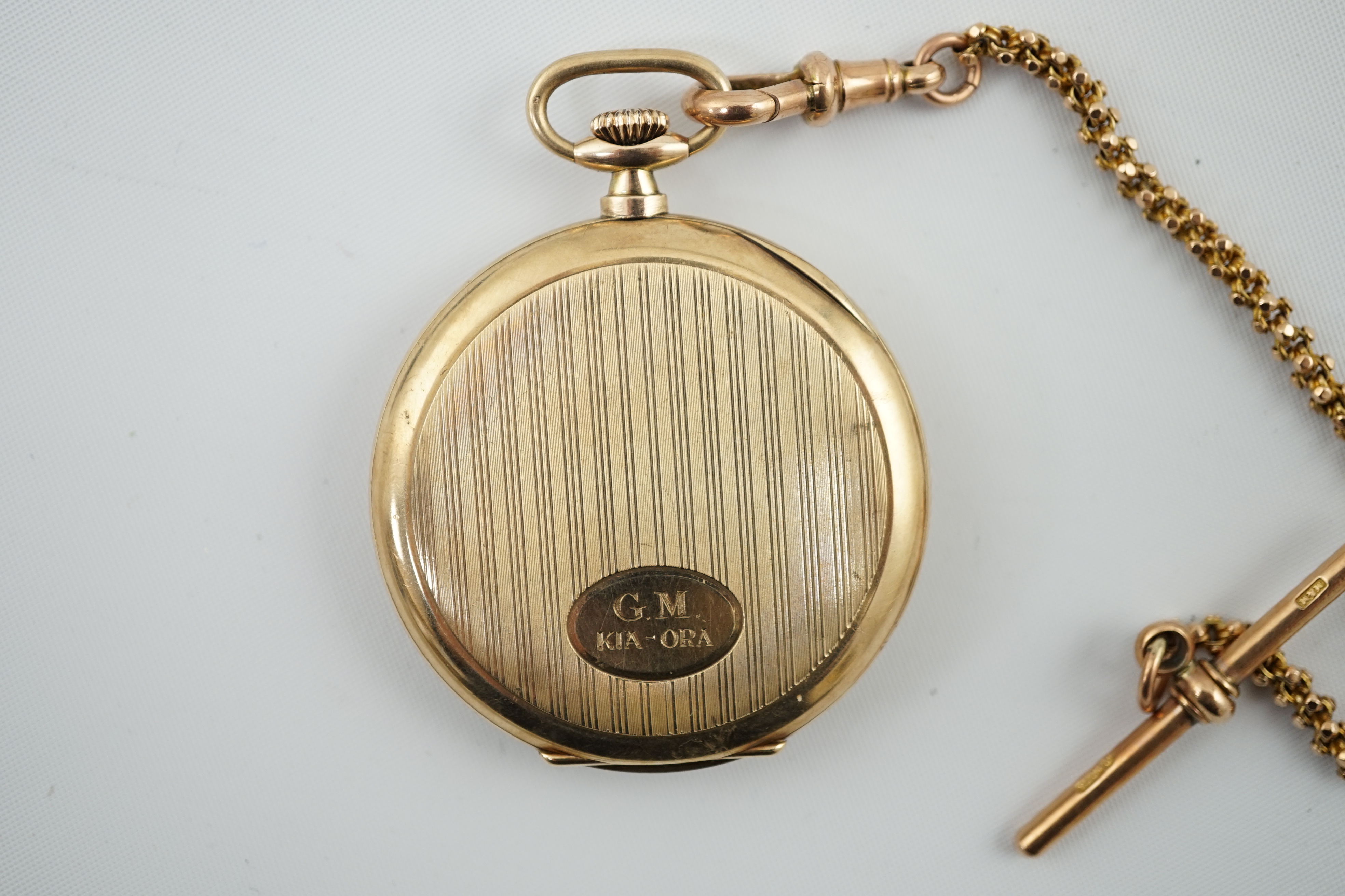 A George V 9ct gold open face dress pocket watch, retailed by William Greenwood & Sons, together with a 9ct gold albert